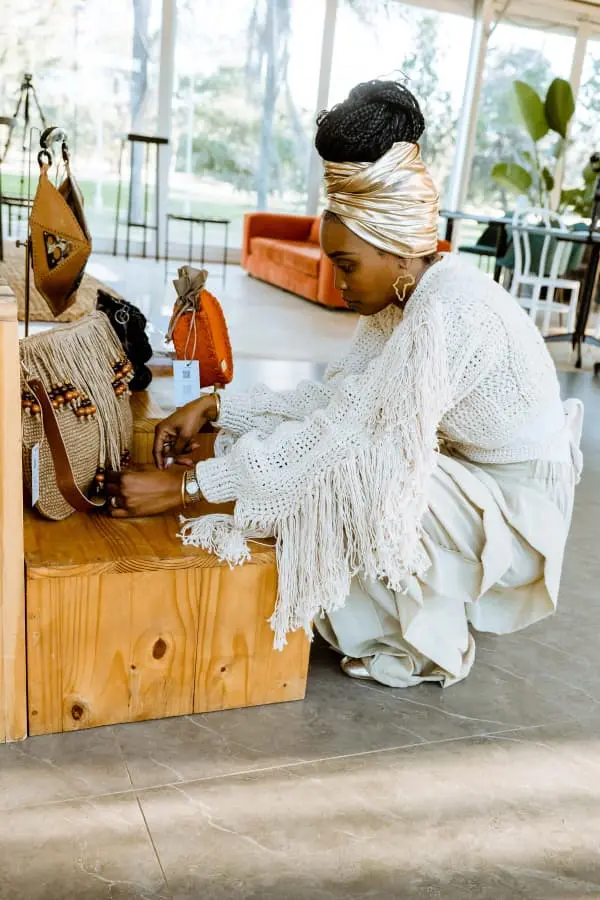 PatCh founder Chido Kaseke arranging handcrafted Zimbabwean handbags